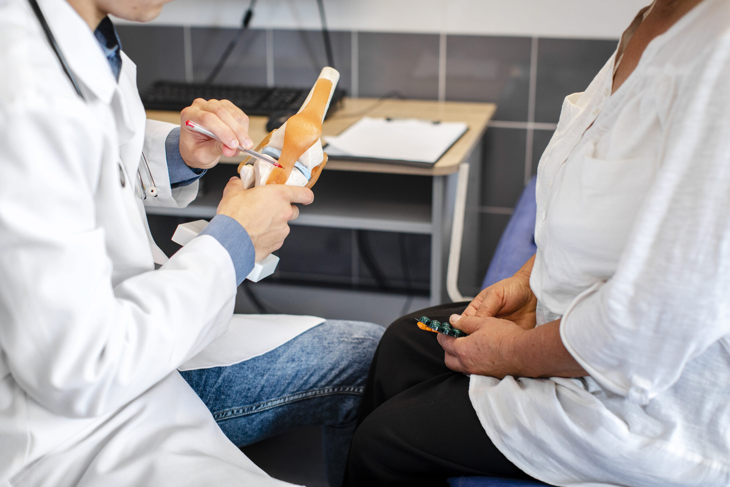 doctor-hands-showing-bone-joints-patient